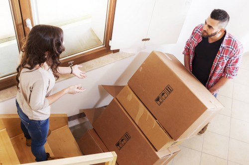 Packed moving boxes and furniture ready for transport in Barnet
