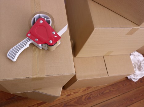 Movers carrying office boxes through a Barnet business property