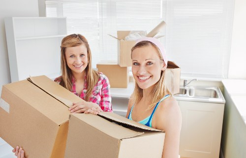 Business moving setup with labelled boxes and workstation equipment in Barnet
