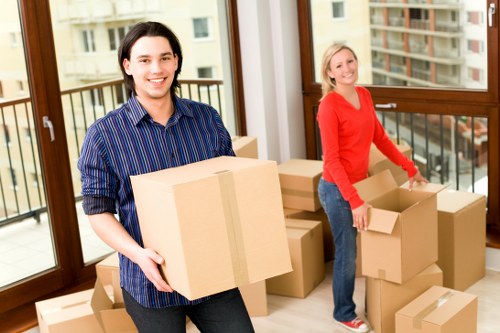 Team handling packed boxes during a house move
